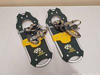 Full view of both 18" Ranger snowshoes showing bindings and deck