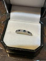 Ring in presentation box showing top view of stones