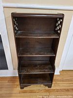 Full frontal view of four-shelf wooden bookcase