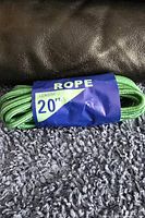 Coiled green rope with blue label indicating rope and length