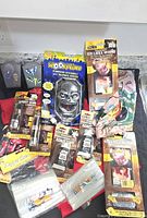 Lot overview showing doorbell, prosthetics, adhesives, toys