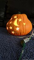 Pumpkin lit showing cutouts glowing