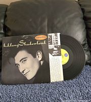 Front cover and record partially removed showing label