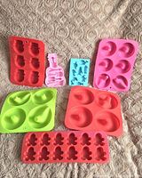 Group shot of all seven silicone moulds laid out on fabric surface