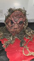 Front view of burlap scarecrow mask showing facial details and teeth