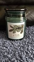 Front view of green jar candle with Aspen Pine label