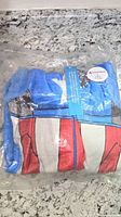 Front view of Captain America fleece onesie in sealed bag