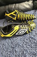 Side view of both cleats showing design and laces