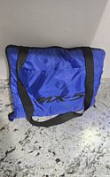 Blue nylon carry case with MX-5 logo and black straps