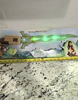 Front of packaged light-up sword showing full length and illumination