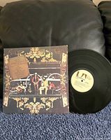 Front cover and vinyl disc showing band photo and UA label