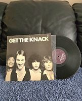 Front cover and vinyl disc partially out of jacket