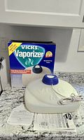 Vicks vaporizer device, box, instructions visible on countertop