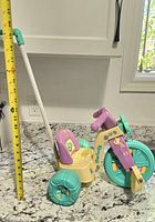 Full side view of tricycle with tape measure for scale