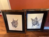 Both framed Guy Coheleach prints side by side on floor