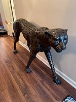 Full side view of bronze cheetah statue