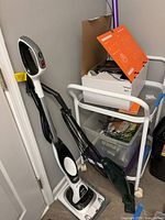 Shark steam mop, Eureka vacuum, accessory storage