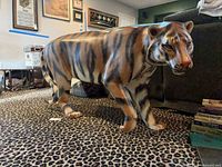 Full side view of tiger statue showing overall form and coloration