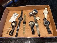 Tray containing nine assorted wristwatches showing overall lot contents