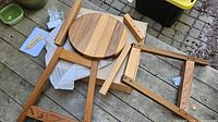 Stool components from one box laid out: round seat, legs, stretchers, hardware