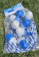Sealed package containing blue and white floats on rope