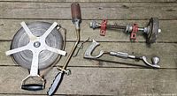 All items laid out: tape reel, blowtorch handle, bench mandrel, auto body rasp