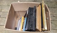 Box containing stacked frames of various sizes and colours