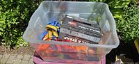 Plastic tote containing mixed straps and boxed winder