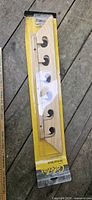 Full view of sealed wooden rod rack in retail packaging