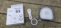 Sound machine in clear plastic tray with USB cable, ring light, box