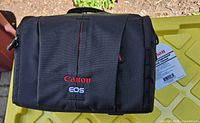 Front view of Canon 700SR EOS shoulder bag with tag attached
