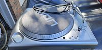 Top view of ION TTUSB turntable with slipmat and cables