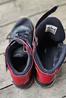 Top view of both sneakers showing strap, tongue labels and interior wear