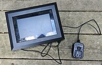 Front view of Kodak SV811 frame with adapter and cords