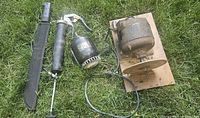 Machete in sheath, grease gun, tested electric motor with sanding disc