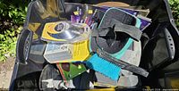 Overview of tote with knee pad, sanding discs, sanding sponges, scrub brush visible
