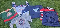 all six jerseys laid out on grass