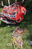 Deflated Airhead G-Force tube with bundled tow ropes on grass