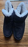 Top view of both black boots showing white fur lining