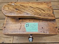 Top view of wooden shoe-shine box showing footrest and wood grain