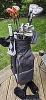 Full set of clubs in stand bag showing woods, irons, putter and bag condition