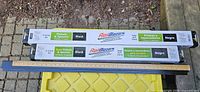 Two Peak RailBlazers boxes labelled pickets & spacers 6 ft black with yardstick and loose bannister section