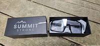 Box opened showing sunglasses in protective wrap