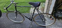 Full side view of Raleigh Grand Prix bicycle showing frame, wheels, saddle, kickstand