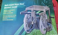 Box front showing Yardworks wall-mount hose reel image and specs