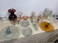 assorted depression glass pieces on table