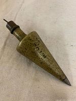 Full view of brass plumb bob showing overall form