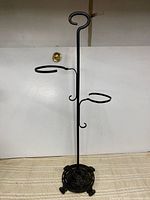 Full view of wrought iron flower pot stand showing overall structure