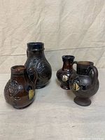 Group shot of four Guerin stoneware jugs