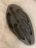 Top view of Lodge cast iron pan showing six jalapeño cavities